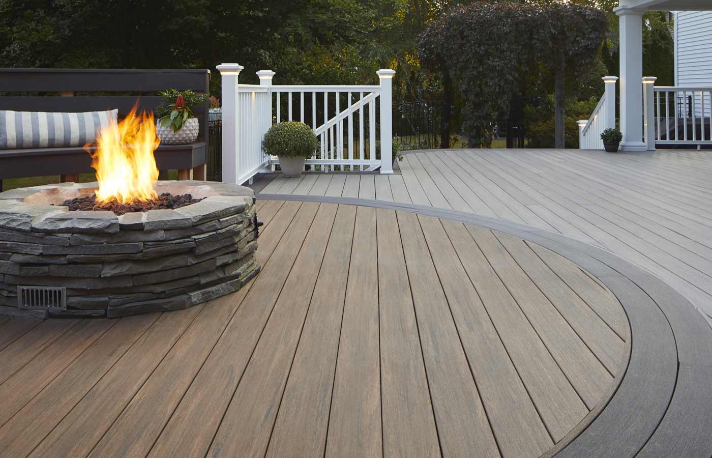 Azek Decking by TimberTech installed in a deck with a bonfire.